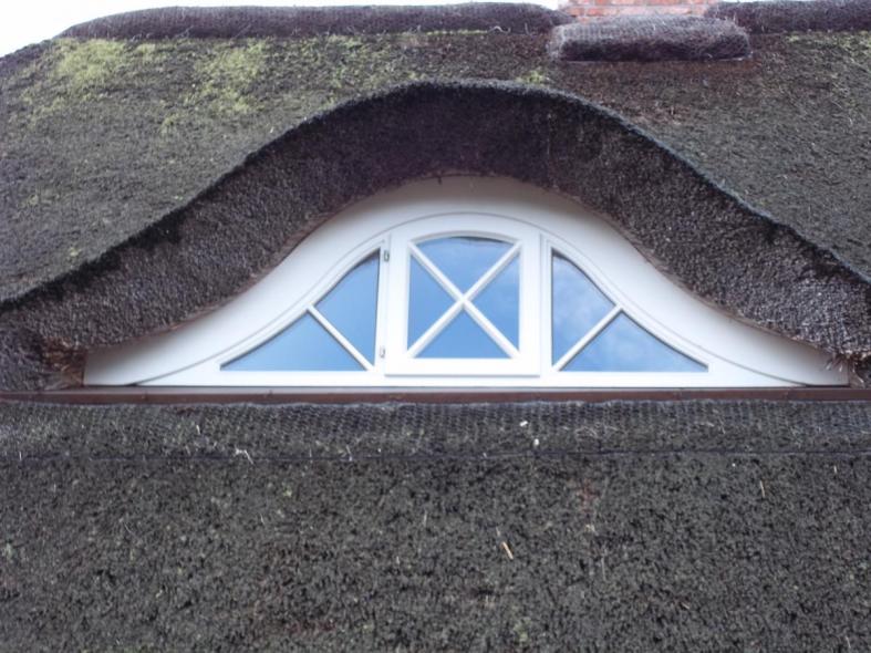 Fenster in weiß bei Schilfdach 